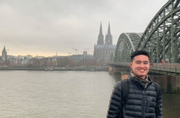 Photo of Case Western Reserve University student Jeremy Nguyen stands in front of a river and bridge