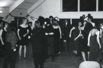 Photo of a people gathered together in a black and white photo from a Lavender Ball from the 1990s