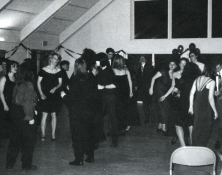 Photo of a people gathered together in a black and white photo from a Lavender Ball from the 1990s