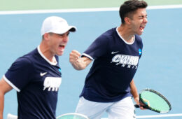 Photo of two Case Western Reserve University men's tennis players cheering on the court