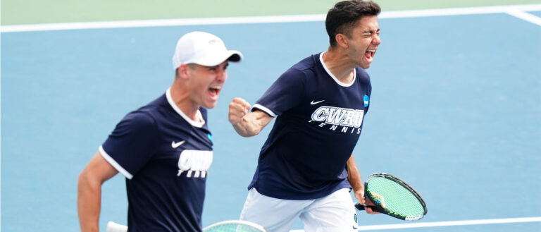 Photo of two Case Western Reserve University men's tennis players cheering on the court