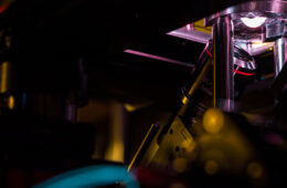 A photo of a 3D imaging machine, with purple light shining up through a tissue sample
