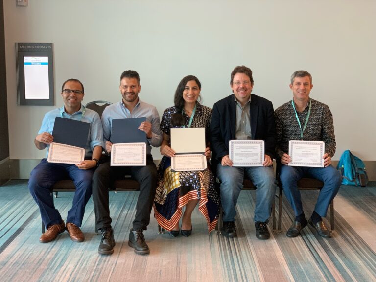 Sherif Elkordy, Tarek ElShebiny, Noha Orabi, Juan Martin Palomo and Carlos Flores-Mir pose together for a photo while seated and holding certificates