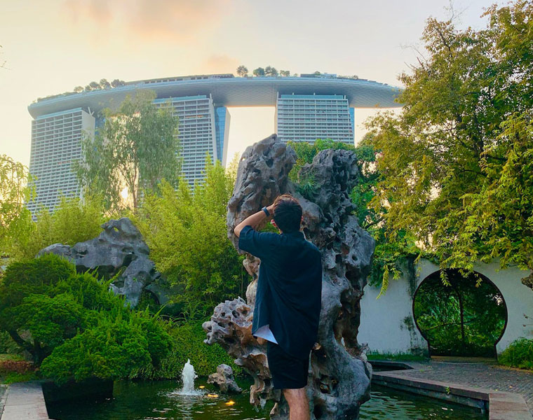 Photo taken from behind of David Silva looking out over the Marina Bay Sands