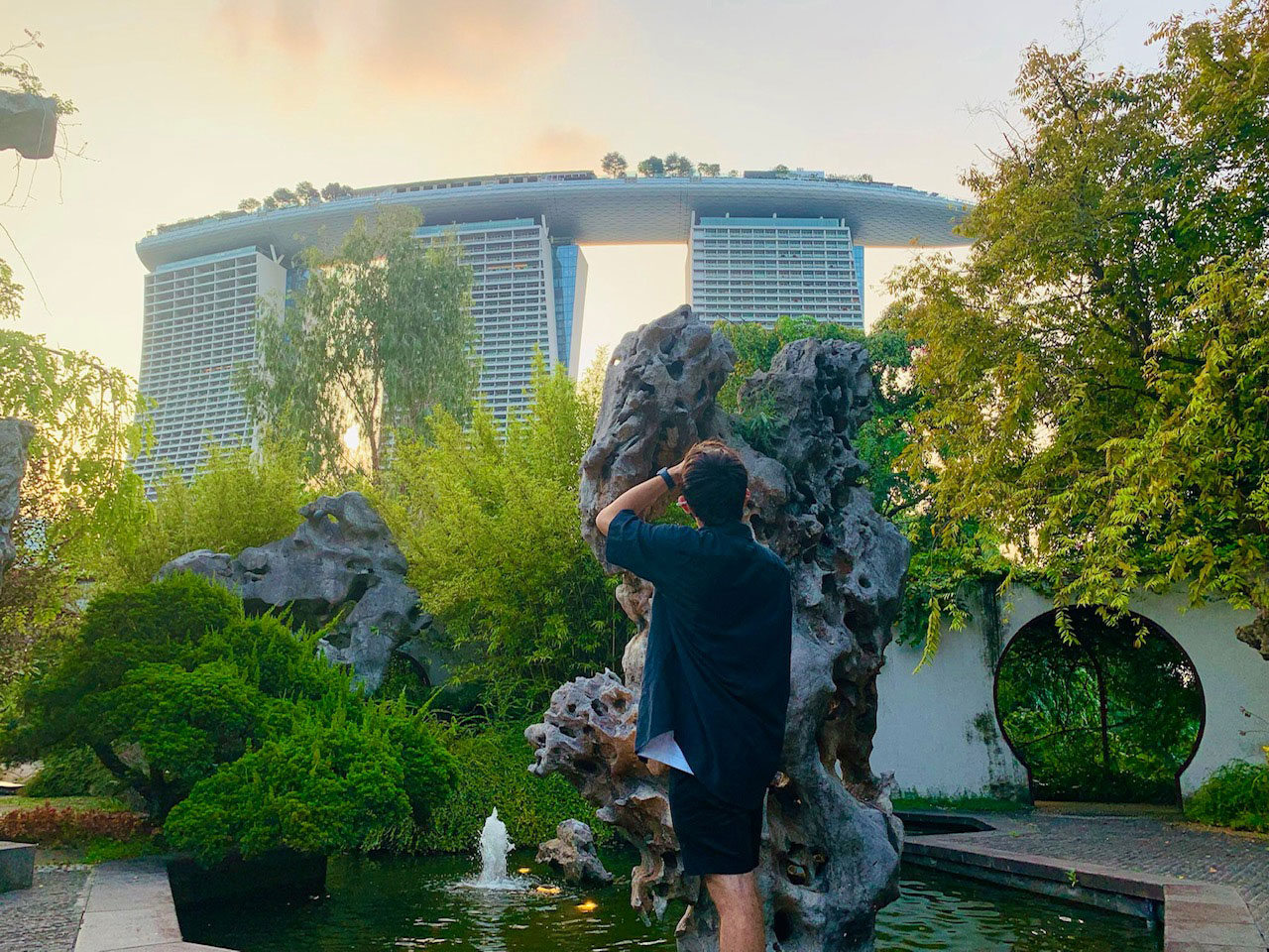 Photo taken from behind of David Silva looking out over the Marina Bay Sands