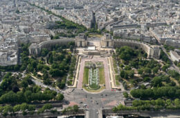 Photo taken from the Eiffel Tower showing the buildings and greenery of Paris