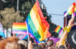 Photo of people holding up pride flags during a Pride event