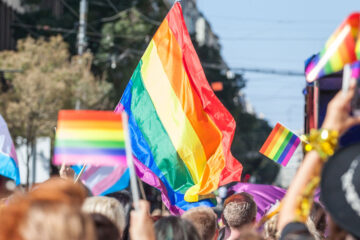 Photo of people holding up pride flags during a Pride event