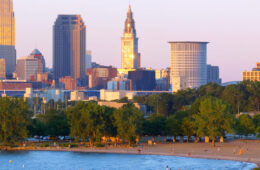 Photo of the sun setting on Cleveland's Edgewater Park with the skyline in the background