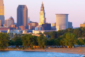 Photo of the sun setting on Cleveland's Edgewater Park with the skyline in the background