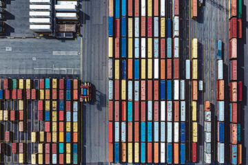Photo taken from above of shipping containers on a loading dock