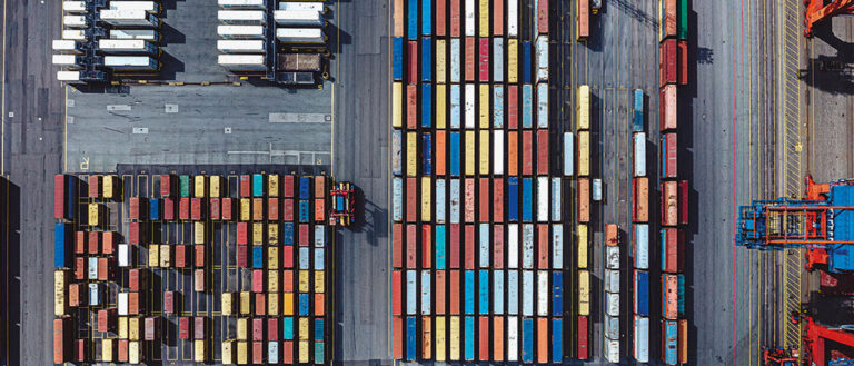 Photo taken from above of shipping containers on a loading dock