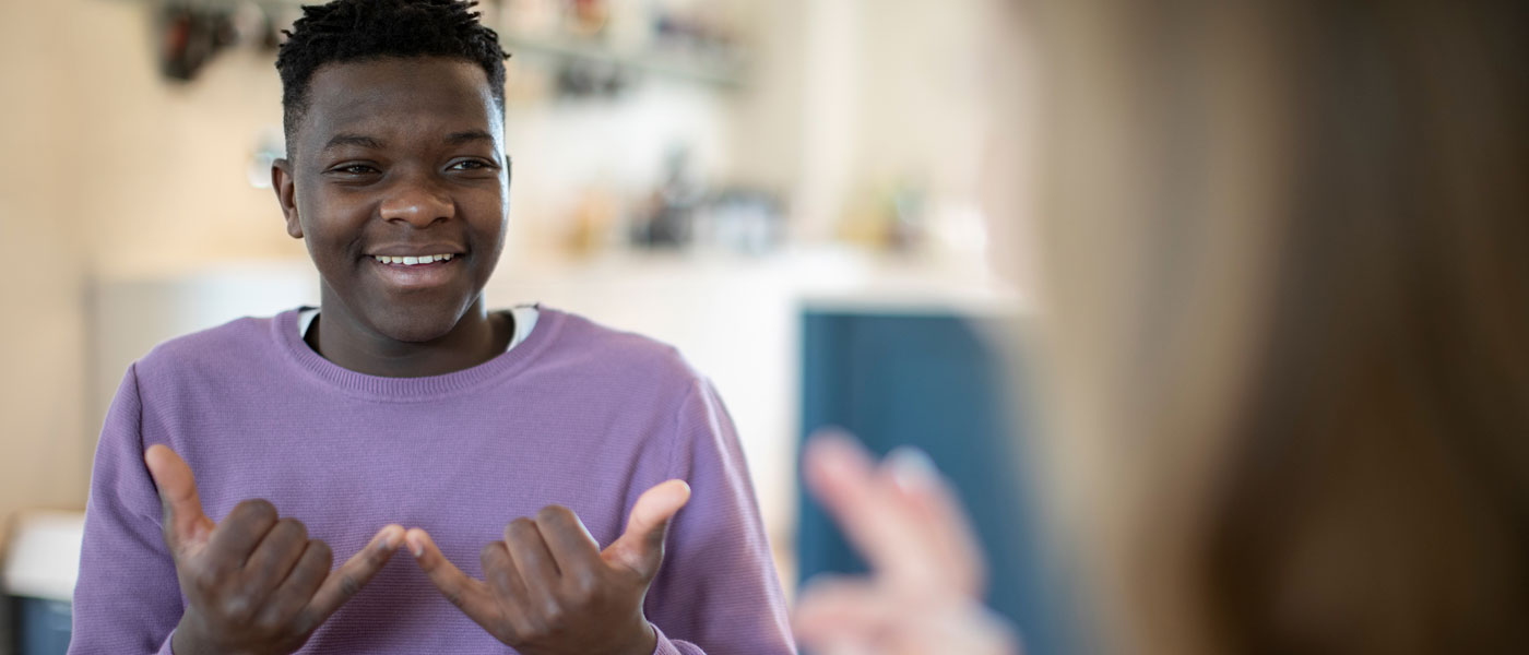 Photo of a teenage boy using American Sign Language