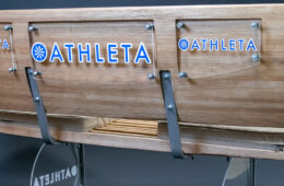 Photo of a tennis bench created by Jules Siegal with the Athleta logo on it