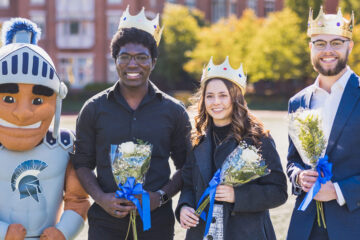 Photo of Spartie with 2022 homecoming court members Jerry Ukwela, Paola Giammattei and Grayson Holt