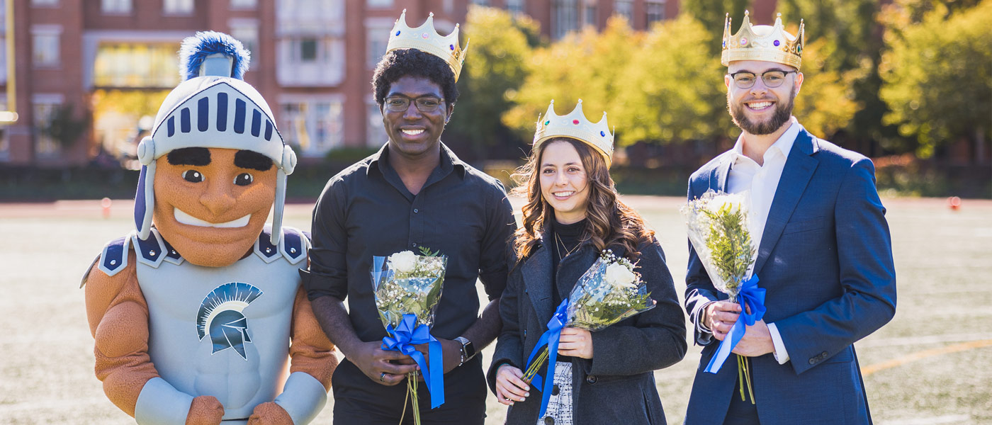 Photo of Spartie with 2022 homecoming court members Jerry Ukwela, Paola Giammattei and Grayson Holt