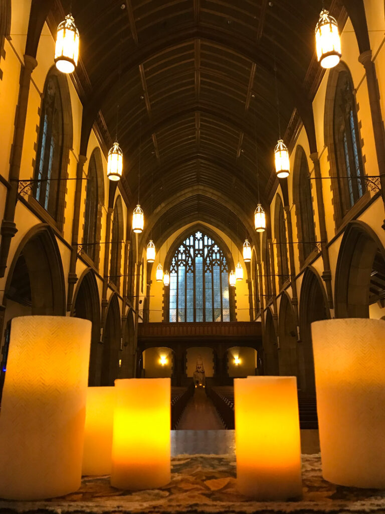 Photo of a candle-lit interior of Amasa Stone Chapel