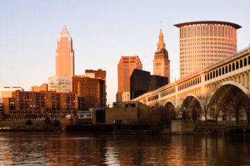 Photo of the Cleveland skyline reflecting onto the Cuyahoga River in fall