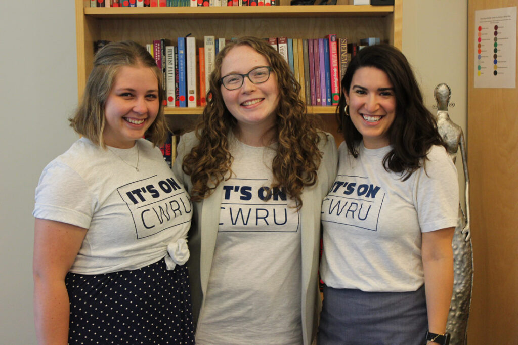 Photo of three individuals posing for a photo while wearing It's on CWRU shirts