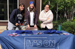 Photo of three individuals posing for a photo while tabling for It's on CWRU
