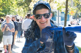 Photo of a student dressed in blue gear and spirit items during a CWRU homecoming event