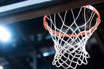 Zoomed in basketball net with a background spotlight