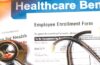 Photo of heathcare benefits form, pill bottle and stethoscope