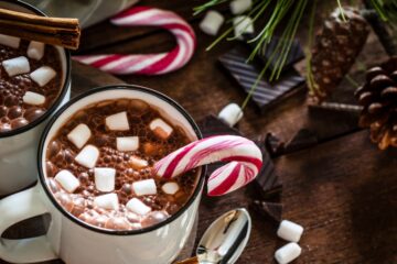 close up of hot chocolatr with marshmallows and candy canes