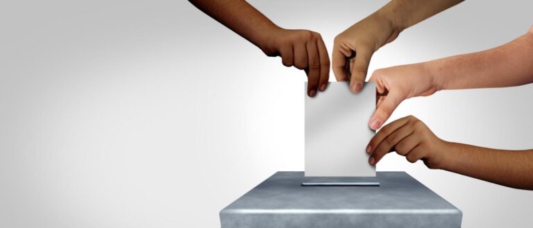 Diverse hands casting a ballot