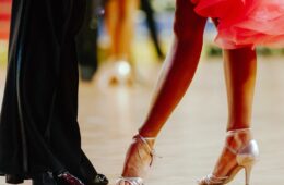 leg shot of man and woman dancing in formal clothes