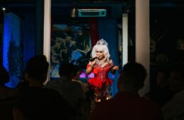 photo of drag queen performing to an audience