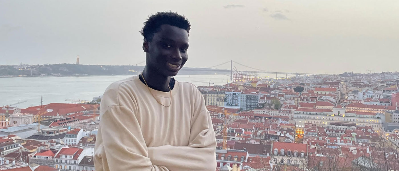 Ibrahima Seck smiles as he poses with Netherland buildings in the background.