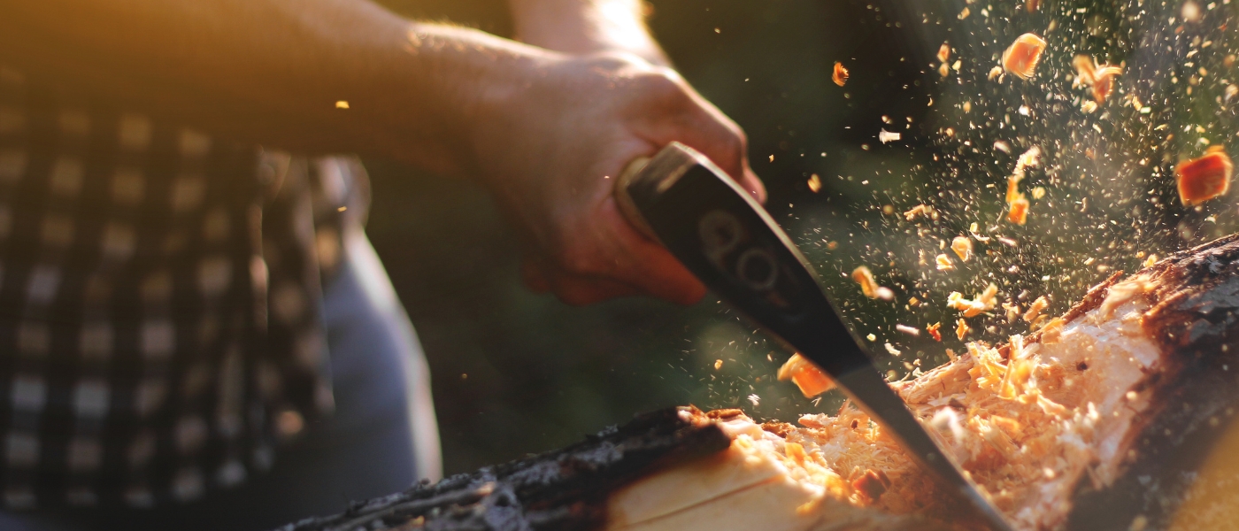 close up of lumberjack chopping wood with chips flying