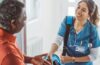 photo of nurse shaking an at-home patient's hand