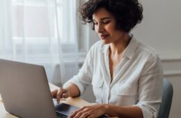 Photo of a woman working on a laptop