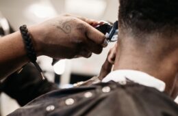 Close up of a barber cutting a client's hair.