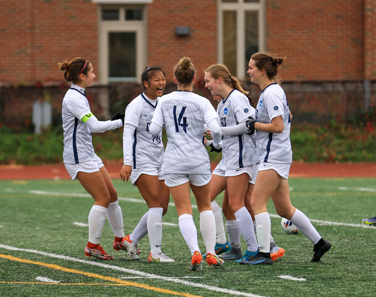 Photo of members of the CWRU women's soccer team coming together in celebration