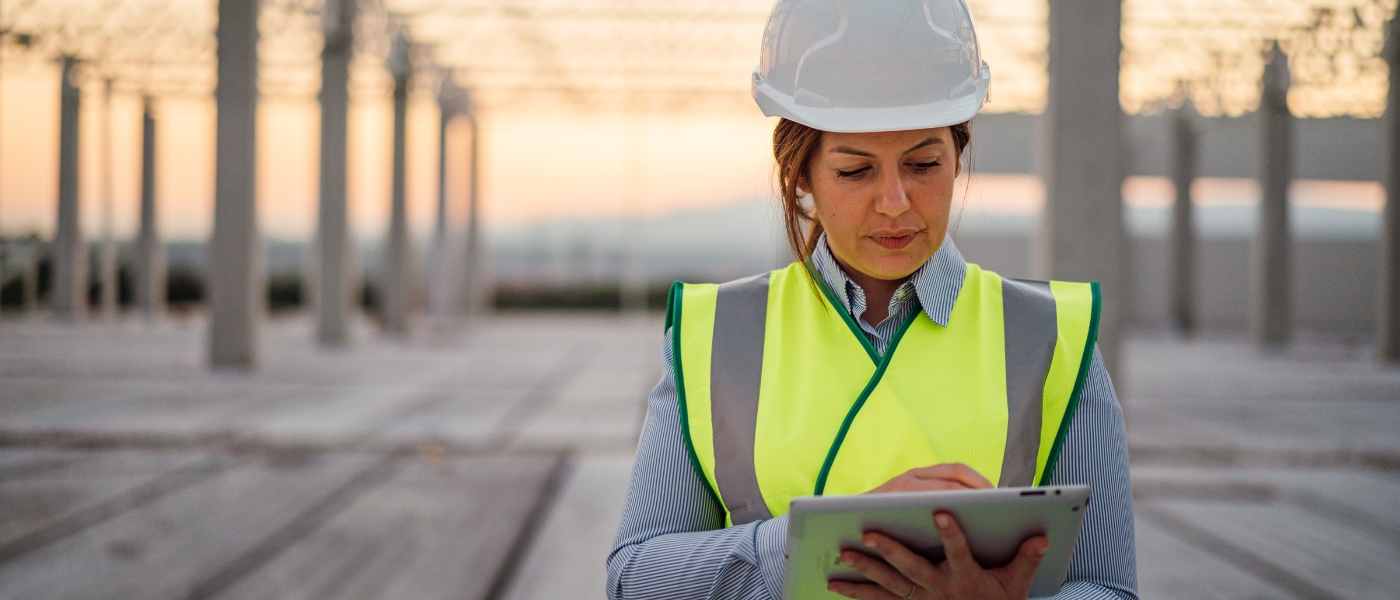 Female construction engineer is using digital tablet on the construction site.