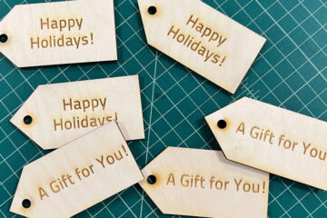 Photo of wood gift tags that say "Happy Holidays" and "A Gift for You"