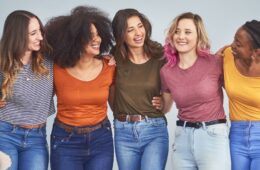 Diverse group of young women interact happily