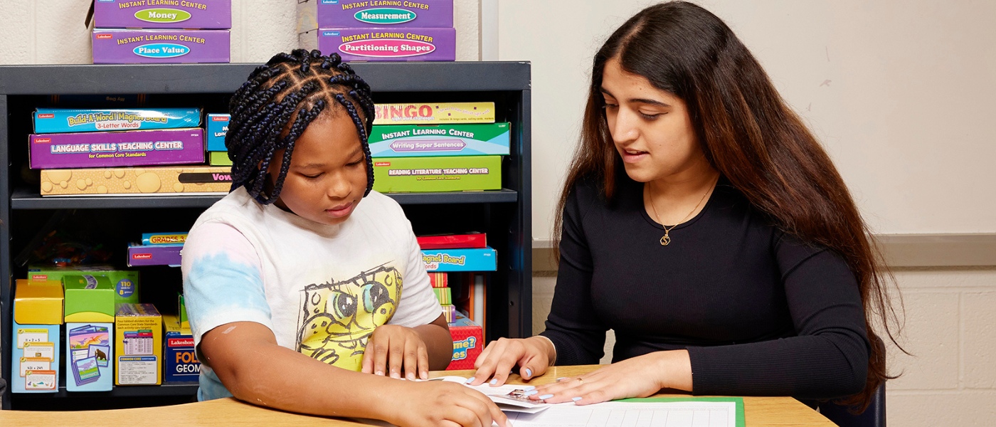 CWRU sophomore Shivangi Nanda reads with fourth grader Clarissa Thomas during an after-school literacy-enrichment program at Mary B. Martin School in Cleveland’s Hough neighborhood.