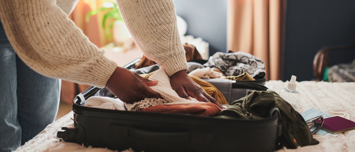 Cropped shot of an unrecognizable woman packing her things into a suitcase at home before travelling
