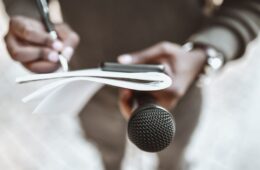 Male journalist preparing questions for press conference