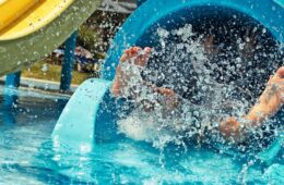 Close up of feet splashing on a water slide