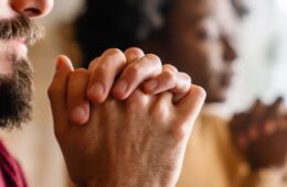 Close up blurry photo of two people praying