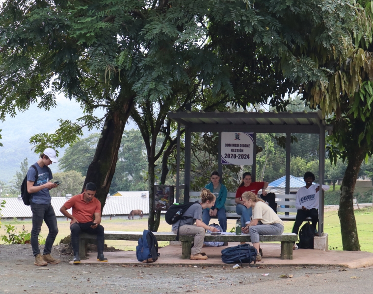 Members of the CWRU chapter of Engineers Without Borders waiting at a bus stop in Cruce de Blanco