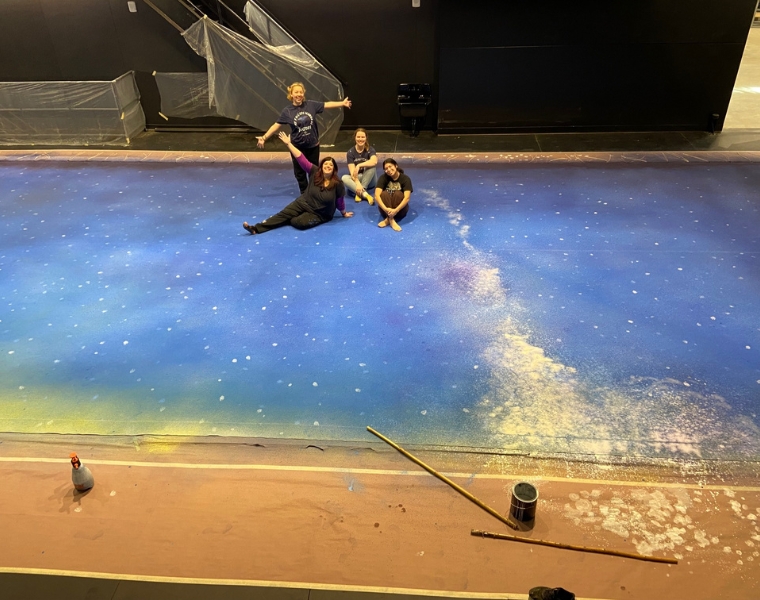 Photo of cast members posing with a background visual for Almost, Maine