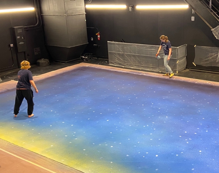 Photo of cast members painting the set for Almost, Maine