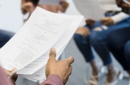 Close up of a group of actors reading a script