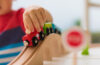 Close up photo on a child playing with a toy train